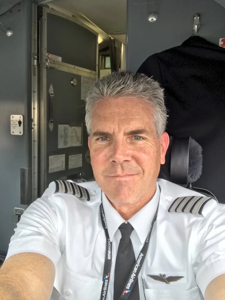 Portrait of Robert Lawrence in captain's uniform in the cockpit